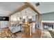 Open-concept living area with wood beam, TV and view into updated kitchen at 2914 Forest Cir, Seffner, FL 33584