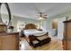 Main bedroom features wood floors, a ceiling fan, and an ensuite bathroom at 2914 Forest Cir, Seffner, FL 33584