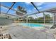 Sparkling screened-in pool area with lounge chairs, patio, and tropical landscaping at 2914 Forest Cir, Seffner, FL 33584