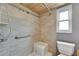 Corner of bathroom with a shower, white toilet, and window with natural light at 2914 Forest Cir, Seffner, FL 33584