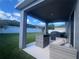 Back patio featuring outdoor seating area and grill, perfect for entertaining at 33191 Azalea Ridge Dr, Wesley Chapel, FL 33545