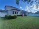 Spacious backyard with lush lawn, white fence, and covered patio at 33191 Azalea Ridge Dr, Wesley Chapel, FL 33545