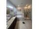 Bathroom with granite counter tops, soaking tub, and glass enclosed shower at 33191 Azalea Ridge Dr, Wesley Chapel, FL 33545