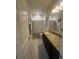 Bathroom featuring a vanity with granite countertop, decorative mirror, shower with modern patterned shower curtain at 33191 Azalea Ridge Dr, Wesley Chapel, FL 33545