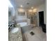 Bathroom with granite counter tops, soaking tub, and glass enclosed shower at 33191 Azalea Ridge Dr, Wesley Chapel, FL 33545