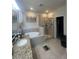 Bathroom with granite counter tops, soaking tub, and glass enclosed shower at 33191 Azalea Ridge Dr, Wesley Chapel, FL 33545