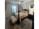 Comfortable bedroom with four poster bed, large windows, and elegant décor at 33191 Azalea Ridge Dr, Wesley Chapel, FL 33545