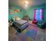 Vibrant bedroom with colorful decor, plush carpeting, and a cozy reading corner, perfect for a young  at 33191 Azalea Ridge Dr, Wesley Chapel, FL 33545