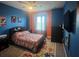 Cozy bedroom featuring a ceiling fan, colorful walls, and comfortable furnishings at 33191 Azalea Ridge Dr, Wesley Chapel, FL 33545