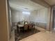 An elegant chandelier hangs over the table and chairs at 33191 Azalea Ridge Dr, Wesley Chapel, FL 33545