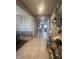 Inviting hallway with tiled floors, elegant decor, and a view leading to other living spaces at 33191 Azalea Ridge Dr, Wesley Chapel, FL 33545