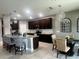 Bright kitchen boasts granite countertops, dark wood cabinets, modern lighting, and a stylish breakfast bar at 33191 Azalea Ridge Dr, Wesley Chapel, FL 33545