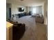 Expansive living area with plush carpeting, a large TV, and cozy seating, ideal for relaxation and entertainment at 33191 Azalea Ridge Dr, Wesley Chapel, FL 33545