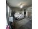 Comfortable primary bedroom features carpet, large windows, and a tufted headboard at 33191 Azalea Ridge Dr, Wesley Chapel, FL 33545