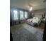 Elegant primary bedroom with a tufted headboard, plush carpeting, and plenty of natural light at 33191 Azalea Ridge Dr, Wesley Chapel, FL 33545