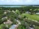 Breathtaking aerial view showcasing a lush neighborhood near a beautiful lake and wooded conservation area at 35077 Whispering Oaks Blvd, Dade City, FL 33523