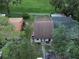 An aerial view showcases residences with peaceful surroundings enhanced by lush greenery and convenient pathways at 35077 Whispering Oaks Blvd, Dade City, FL 33523