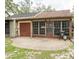 Backyard featuring screened-in patio, grill, and exterior of home at 35077 Whispering Oaks Blvd, Dade City, FL 33523