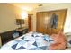 Bedroom with a closet, TV, quilt bedding, and a window for natural light at 35077 Whispering Oaks Blvd, Dade City, FL 33523