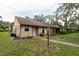 Quaint one-story home with a well-maintained lawn and pathway leading to the entrance at 35077 Whispering Oaks Blvd, Dade City, FL 33523
