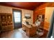 Charming home office with wood paneled walls, desk, bookshelves, and ample natural light at 35077 Whispering Oaks Blvd, Dade City, FL 33523