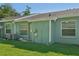 Exterior backyard view showing the home's back door and windows at 38237 Eucalyptus Dr, Zephyrhills, FL 33542