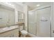 Bright bathroom featuring a shower with glass doors, neutral tile, and a vanity at 38237 Eucalyptus Dr, Zephyrhills, FL 33542