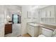 Bathroom featuring a sink and storage, with a glimpse into the bedroom at 38237 Eucalyptus Dr, Zephyrhills, FL 33542