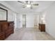 Spacious bedroom with neutral carpet, ceiling fan, and closet access at 38237 Eucalyptus Dr, Zephyrhills, FL 33542