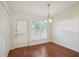 Bright dining area featuring wood floors, a modern light fixture, and a door to the outside at 38237 Eucalyptus Dr, Zephyrhills, FL 33542