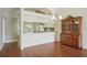 Dining room with hardwood floors, decorative china cabinet and peek-a-boo to kitchen at 38237 Eucalyptus Dr, Zephyrhills, FL 33542
