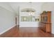Bright dining room with hardwood floors, a large china cabinet and open view to kitchen at 38237 Eucalyptus Dr, Zephyrhills, FL 33542