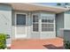 Charming front entrance with a gray door, complemented by a bay window providing natural light at 38237 Eucalyptus Dr, Zephyrhills, FL 33542