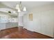 Open-concept kitchen featuring white cabinets, modern appliances, and wood floors, next to the dining area at 38237 Eucalyptus Dr, Zephyrhills, FL 33542