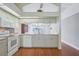 Updated kitchen with breakfast bar, hardwood floors, and white appliances and cabinets at 38237 Eucalyptus Dr, Zephyrhills, FL 33542