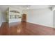 Open-concept living room with hardwood floors, flowing into the kitchen area with a breakfast bar at 38237 Eucalyptus Dr, Zephyrhills, FL 33542