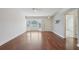 Spacious living room with hardwood floors, a ceiling fan, and a bright window for natural light at 38237 Eucalyptus Dr, Zephyrhills, FL 33542
