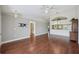 Spacious living room featuring hardwood floors, and an open layout design to kitchen at 38237 Eucalyptus Dr, Zephyrhills, FL 33542