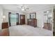 Bright main bedroom featuring a ceiling fan, large windows and a large dresser at 38237 Eucalyptus Dr, Zephyrhills, FL 33542