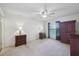 Spacious bedroom featuring a ceiling fan, two side tables, and a large dresser at 38237 Eucalyptus Dr, Zephyrhills, FL 33542