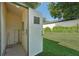 Outdoor storage room has a door, a light fixture, and is adjacent to the backyard at 38237 Eucalyptus Dr, Zephyrhills, FL 33542
