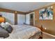 Bedroom featuring a wooden bed frame with a view of double closets and wall art at 4215 E Bay Dr # 1706A, Clearwater, FL 33764
