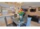 Open concept dining area with modern glass table and view of the living room and kitchen at 4215 E Bay Dr # 1706A, Clearwater, FL 33764