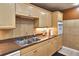 Functional kitchen featuring light wood cabinetry, tiled backsplash, and essential appliances at 4215 E Bay Dr # 1706A, Clearwater, FL 33764
