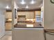 Charming kitchen featuring wood cabinets, neutral countertops, and modern appliances at 4215 E Bay Dr # 1706A, Clearwater, FL 33764