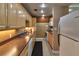 Well-maintained kitchen with wooden cabinets, countertops, and modern appliances at 4215 E Bay Dr # 1706A, Clearwater, FL 33764