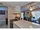 View of kitchen cooktop with tile backsplash next to an eating area with a glass table and ceiling fan at 4215 E Bay Dr # 1706A, Clearwater, FL 33764