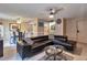 Stylish living room featuring a comfortable leather sectional, tile flooring, and a dining area with modern furnishings at 4215 E Bay Dr # 1706A, Clearwater, FL 33764