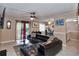 Comfortable living area with a large sectional sofa, tile flooring, and access to a dining area and outdoor space at 4215 E Bay Dr # 1706A, Clearwater, FL 33764