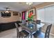 Cozy living space with a glass table, black sofa, and a large window at 4215 E Bay Dr # 1706A, Clearwater, FL 33764